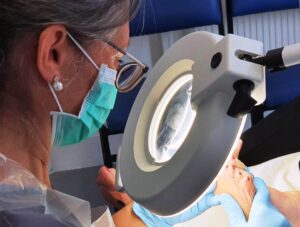 Podiatrist Nina Neal examining a patient's foot